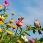 Bird perched on a sunflower stem in a lush colorful flower garden with a bee feeding on the flower's nectar